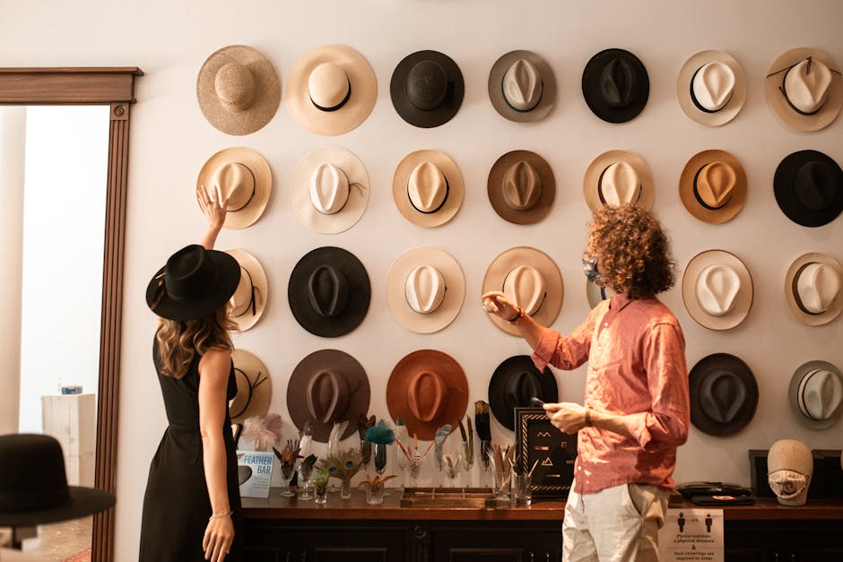Elegant hat display in a fashion boutique with two stylish adults browsing.