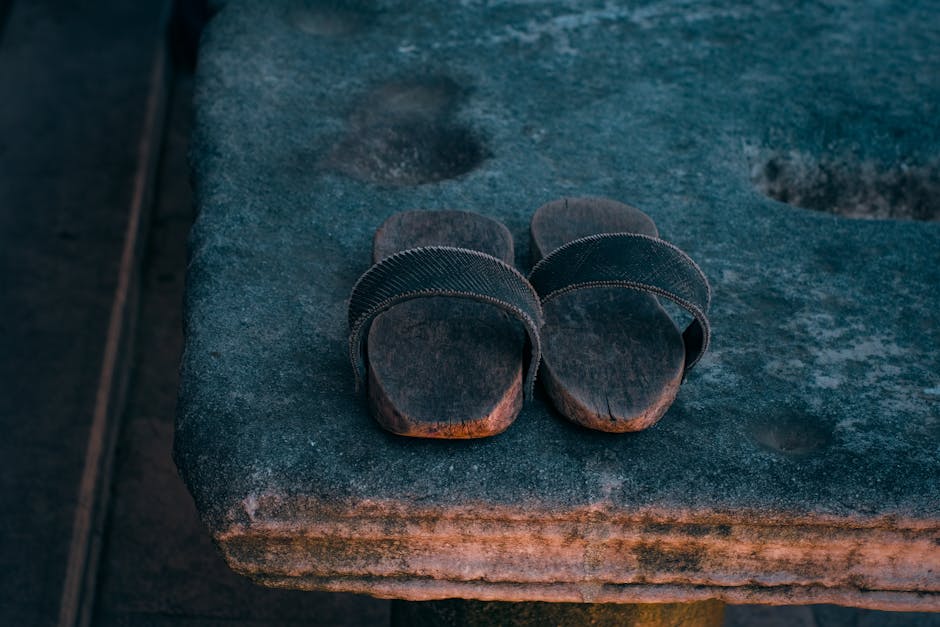 Vintage wooden sandals on rugged stone evoke nostalgia and tradition.