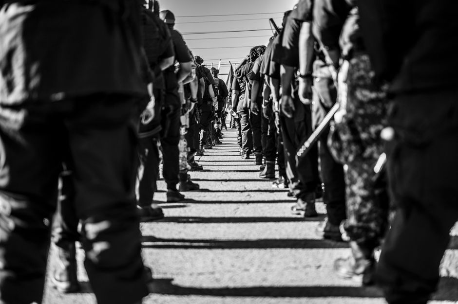 Black and white photo of soldiers standing in formation outdoors in Tulsa.