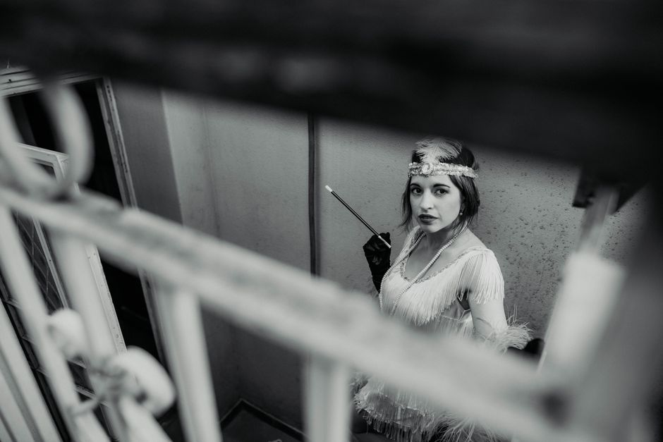 Black and white photo of a vintage performer with headdress in Buenos Aires.
