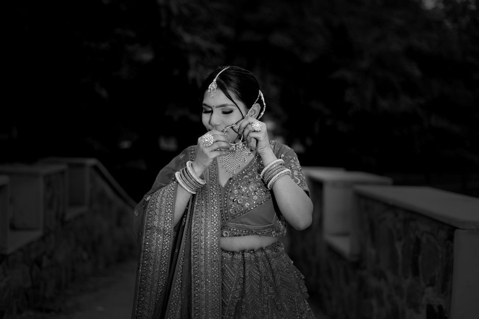 A stunning South Asian bride in traditional attire captured outdoors in Lucknow, Uttar Pradesh.