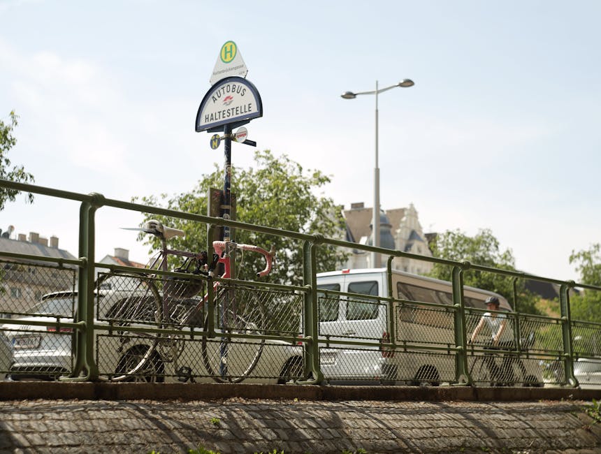 Urban scene of a bus stop with bicycles and vehicles in Vienna on a sunny day.